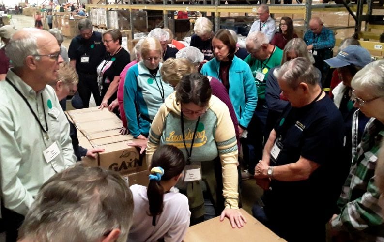 Group packs food, essentials at Global Aid Network